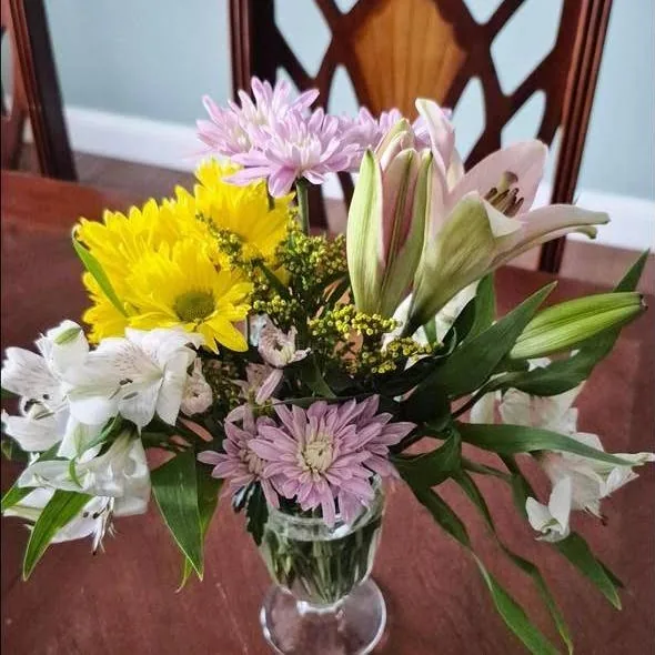 Easter arrangement of lilies, mums, alstroemeria and solidago