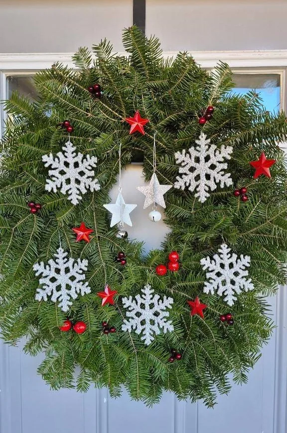 Balsam wreath with white snowflakes and red stars
